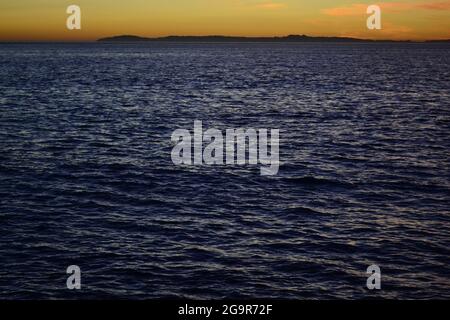 Heavy colour sea waves during sunset. The low light and the granulosity gives an relaxing texture to the photo. Stock Photo