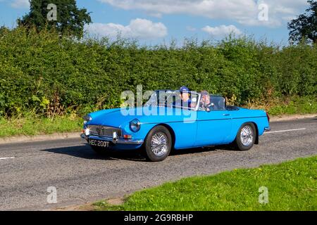 1978 blue MG B British sports vehicle en-route to Capesthorne Hall classic July car show, Cheshire, UK Stock Photo