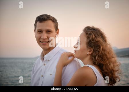 Woman put her hand on the man's shoulder Stock Photo