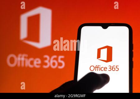 In this photo illustration the Microsoft Office 365 logo is displayed on seen on a smartphone and a pc screen. Stock Photo