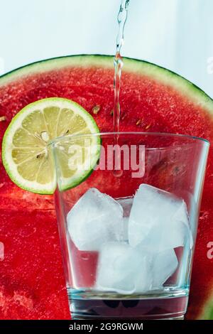 Sparkling water that is poured into a glass Stock Photo