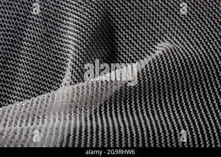 Texture of a fine white mesh on black background. Stock Photo