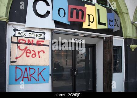 Los Angeles, CA USA - June 28, 2021: Boarded up theatre box office with words One Year Dark painted on plywood, a different human toll from the corona Stock Photo