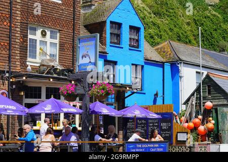 Hastings, Sussex, England July 04 2021: The weather is good and tourists enjoy eating al fresco in the streets of the old town in East Hill, Hastings Stock Photo