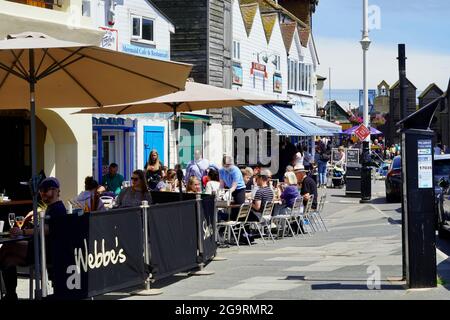 Hastings, Sussex, England July 04 2021: The weather is good and tourists enjoy eating al fresco in the streets of the old town in East Hill, Hastings Stock Photo