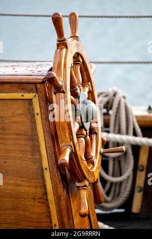 wooden ship's wheel of a tall ship Stock Photo