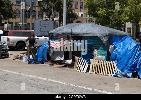 Los Angeles, CA USA - Julyl 3, 2021: Homeless veteran living in a tent outside the Veterans Administration hospital and grounds Stock Photo