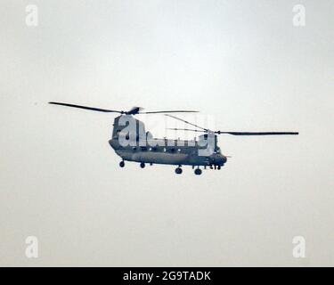 Glasgow, Scotland, UK, 27th  July, 2021. Low  level flying military chinook helicopters  over the  city caused concern as previous army manoeuvre  in the sky sparked corona virus conspiracies earlier in the year. It was seen and heard flying a circular low fly pass over the west of the city .  Credit: Gerard Ferry/Alamy Live News Stock Photo