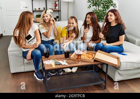 Group of young friends woman having party with costume accessories at home. Stock Photo