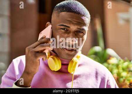 Young african american man smiling happy talking on the smartphone at the city. Stock Photo