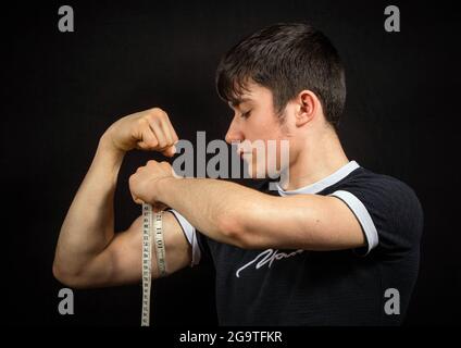 Man Measuring His Biceps With Measuring Tape On White Background Stock  Photo - Alamy