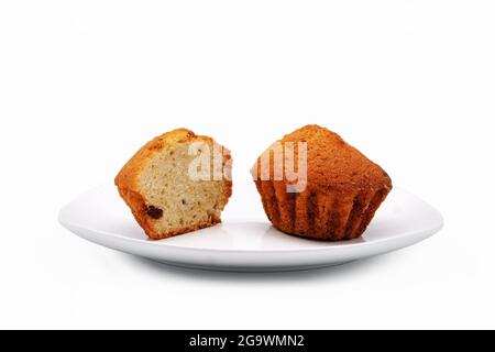 Cupcakes on a white plate. Close-up. Isolated over white background. Stock Photo