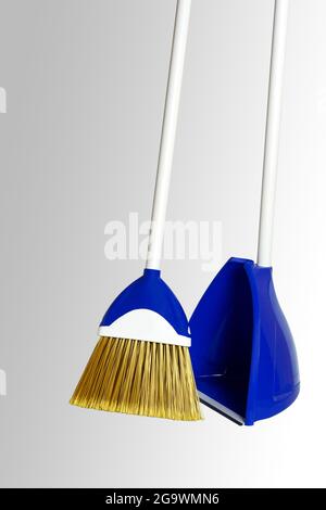 Broom with dustpan set. Close-up. Isolated on a gray background. Stock Photo