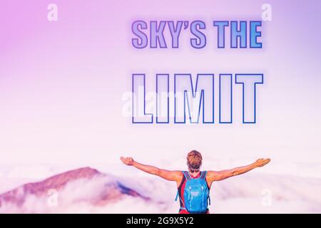 SKY'S THE LIMIT sentence written on pink sky with clouds at sunset copy space. Man with open arms inspirational picture for motivational quote for Stock Photo