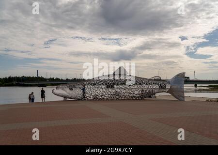 Tornio, Finland - 24 July, 2021:tourists enjoy a visit to Tornio and admire the giant salmon sculpture in the city center Stock Photo
