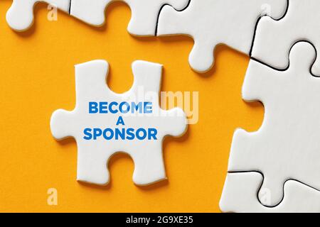 Become a sponsor message on a puzzle piece apart form the assembled pieces. Financial sponsorship support or charity donation concept. Stock Photo
