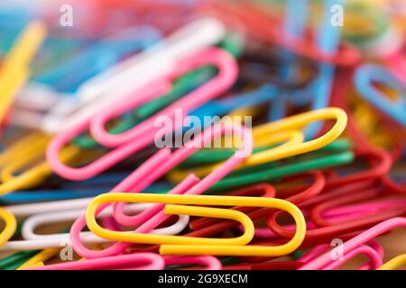 Pile of colorful paper clips macro abstract background Stock Photo