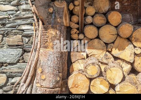 firewood at a stone house in the alps Stock Photo