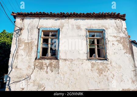 Abandoned stone house with broken windows. Stock Photo