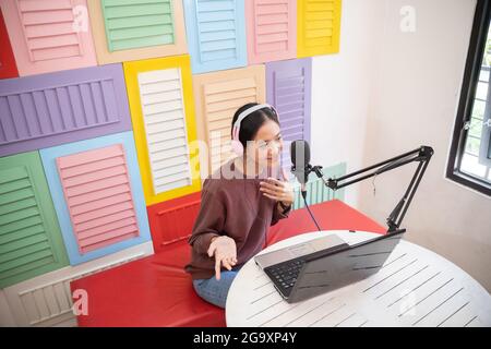 cheerful girl in front of microphone during podcast Stock Photo