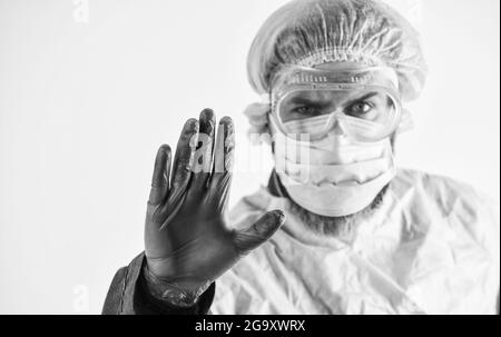 Stop. Personal protective equipment. Man wearing protective mask. Coronavirus pandemic. Garments protect health. Infection prevention. Face protection Stock Photo