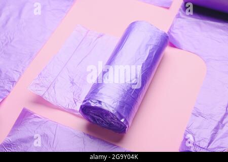 Rolls of garbage bags on color background Stock Photo