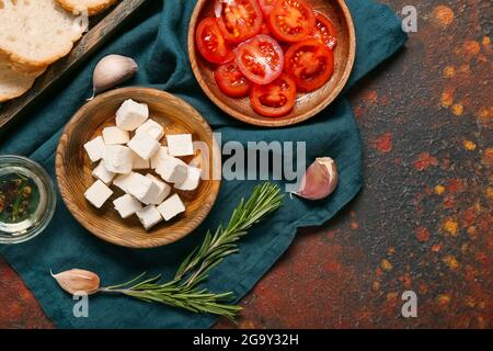 Composition with delicious pieces of feta cheese on grunge background Stock Photo