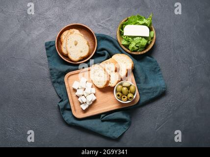 Composition with delicious pieces of feta cheese on dark background Stock Photo