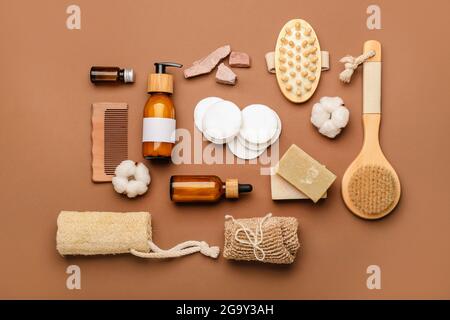 Composition with cotton pads, comb, brush and cosmetic products on color background Stock Photo