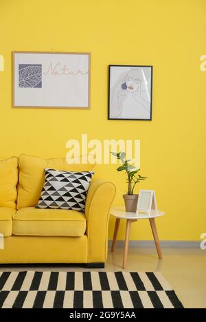 Interior of stylish living room with pictures Stock Photo - Alamy