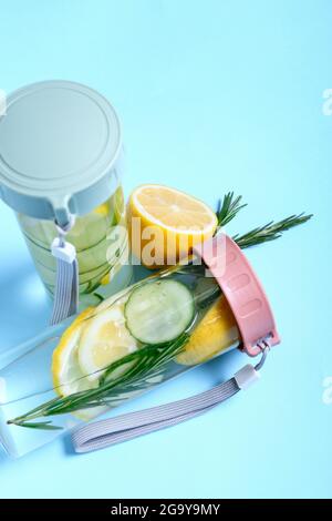 Bottles with cucumber lemonade on color background Stock Photo