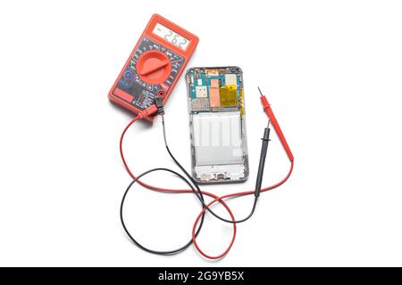 Disassembled mobile phone with multimeter on dark background Stock ...