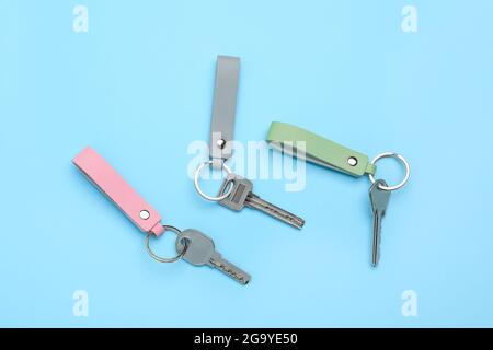 Keys with leather keychains on color background Stock Photo