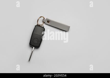 Car key with leather keychain on grey background Stock Photo
