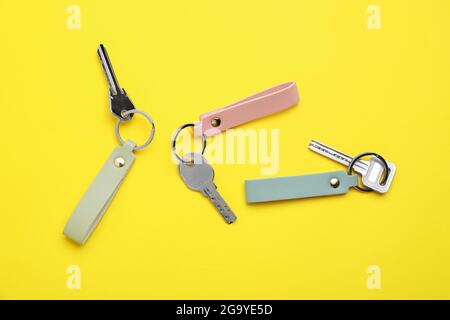 Keys with leather keychains on color background Stock Photo