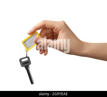 Woman holding key with plastic tag on white background Stock Photo