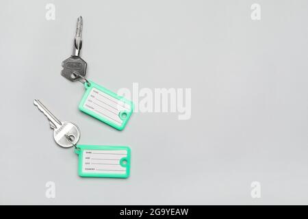 Keys with plastic tags on grey background Stock Photo
