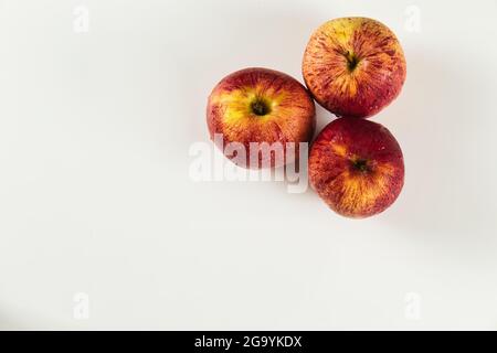 foreground of top view of three red apples with drops on white background Stock Photo
