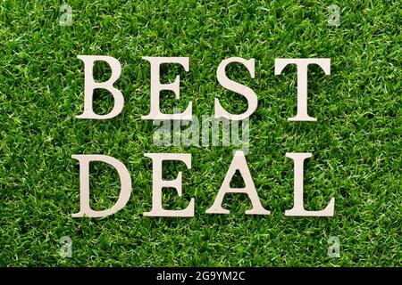 Wood alphabet in word best deal on artificial green grass background Stock Photo