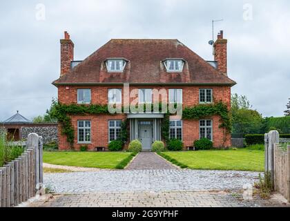 The Red House, a large red brick house in Shore Road in Bosham, West Sussex, England, UK. Stock Photo