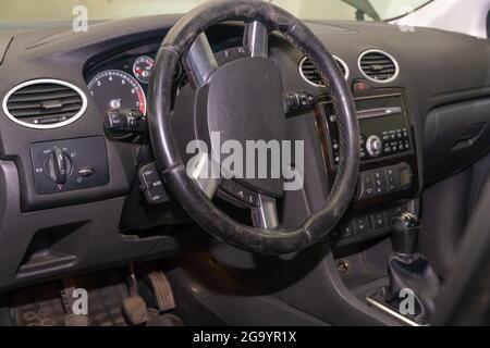 Car steering wheel in the dust inside the car, Car steering wheel replacement Stock Photo