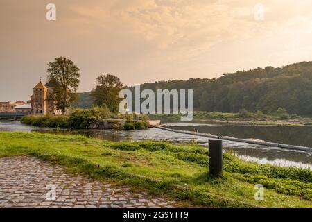 River Mulde near Grimma in Saxony with building 'Grossmuehle', german for large mill, in background in evening light Stock Photo