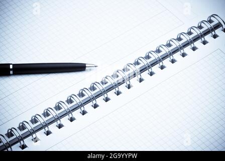 black ballpoint pen on a spiral notebook Stock Photo
