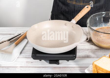 Frying french toast in a nonstick frying pan. Stock Photo