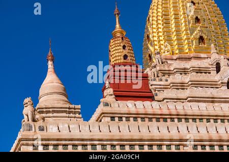 Ornate details from Ananda Temple under a blue sky in Bagan, Myanmar