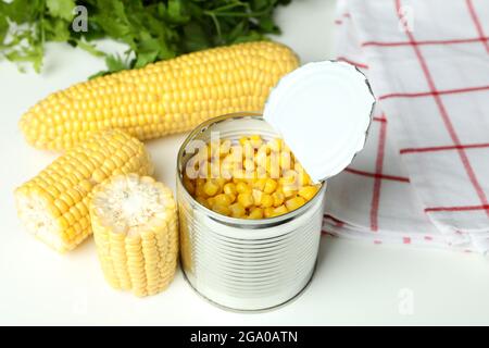 Raw corn and canned corn on white table Stock Photo