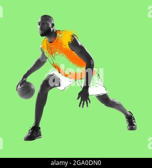 Zine collage. Young man, basketball player in drawn sports uniform isolated on green background. Illustration, painting. Concept of sport, game Stock Photo