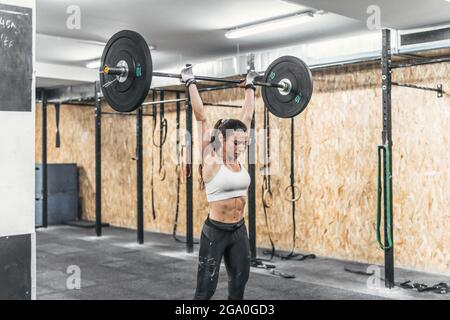 woman with dumbbells in the gym doing crossfit Stock Photo