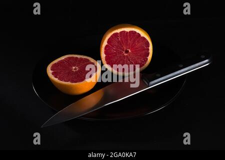 red grapefruit on black background Stock Photo