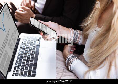 Colleagues working together in modern car using devices and gadgets during creative meeting Stock Photo
